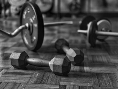 Iron weights arranged neatly on a dark wooden floor